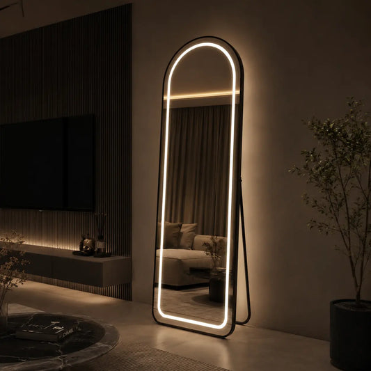 Modern living room with a large floor mirror and decorative items.