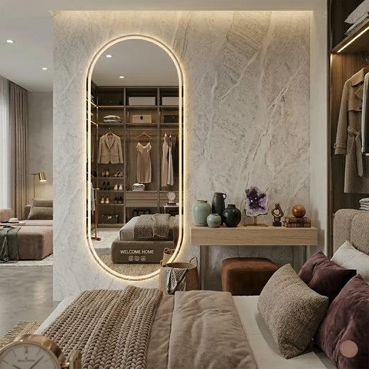 Luxury full-length oval standing LED mirror with warm ambient backlighting in a modern minimalist bedroom dressing area layout