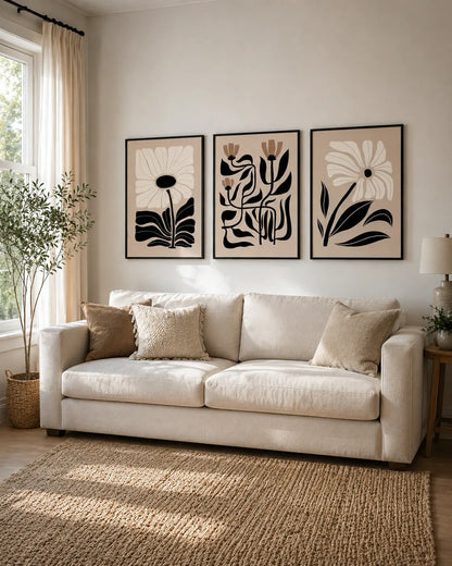 3 piece framed wall art set with botanical artwork above a living room sofa