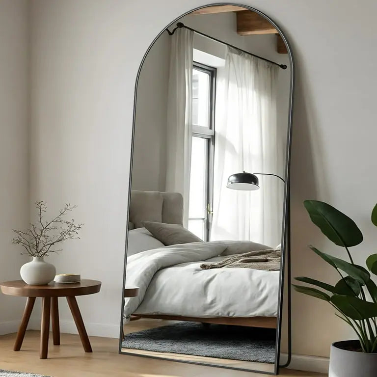 Arched_standing_mirror_with_sleek_frame_for_modern_bedroom_and_living_room
