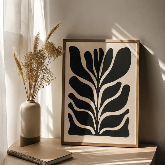 Black leaf wall art featuring a bold botanical leaf silhouette in a modern frame by Decorsz Pakistan.