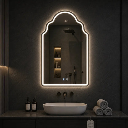 Bathroom vanity with a illuminated mirror above the sink.