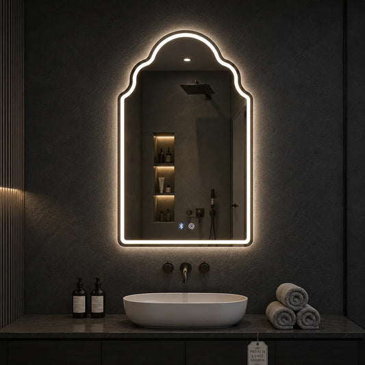 Bathroom vanity with a illuminated mirror above the sink.