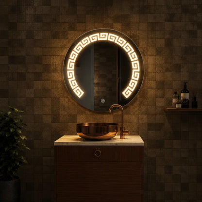 Round illuminated mirror in a bathroom setting with a sink and decorative plant.