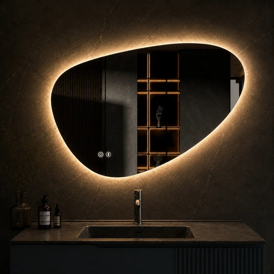 Bathroom vanity with a large illuminated mirror on a gray marble wall.