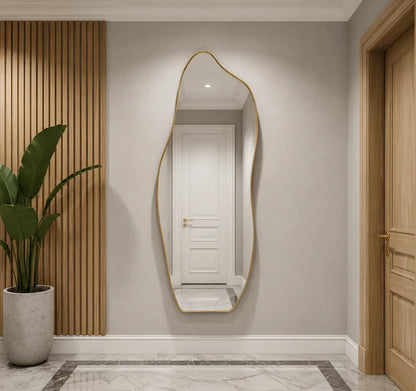 Full-length asymmetrical wall mirror with a sleek thin gold frame, mounted in a modern minimalist entryway hallway