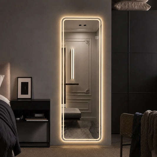 Modern bedroom with a large illuminated floor mirror, dark furniture, and decorative elements.