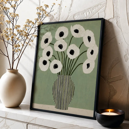 Floral wall art featuring white botanical flowers on a muted green background with a black frame, styled in a modern neutral interior.