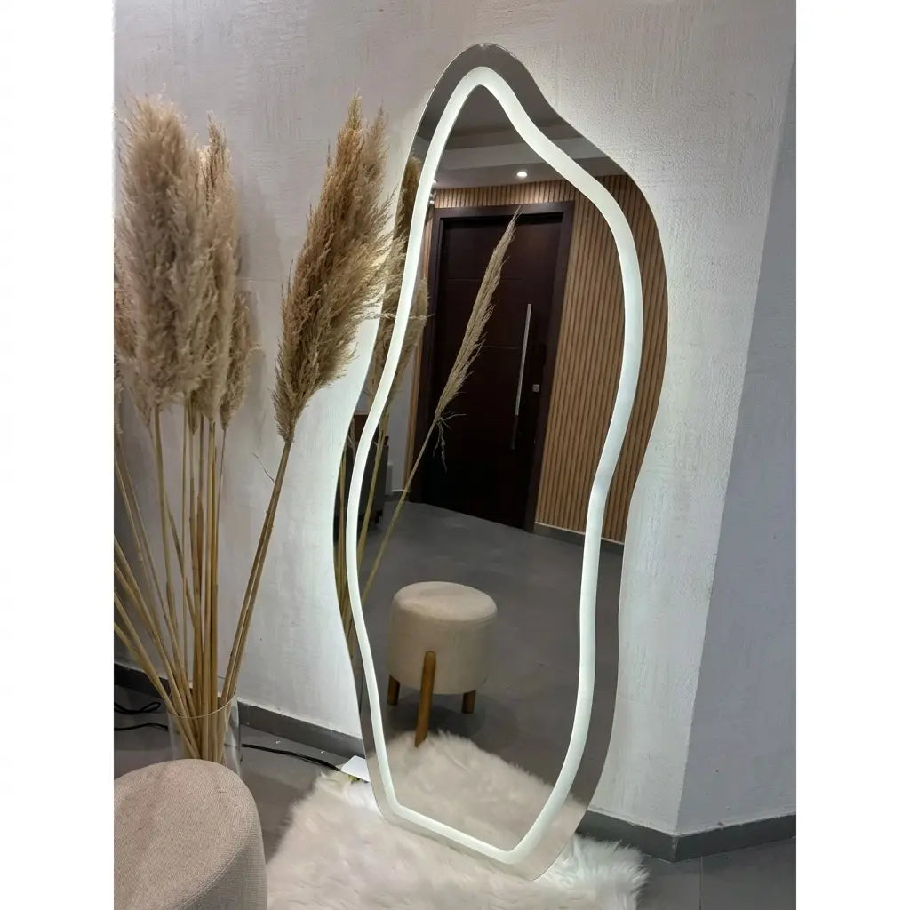 Modern floor mirror with a unique frame design in a room setting.