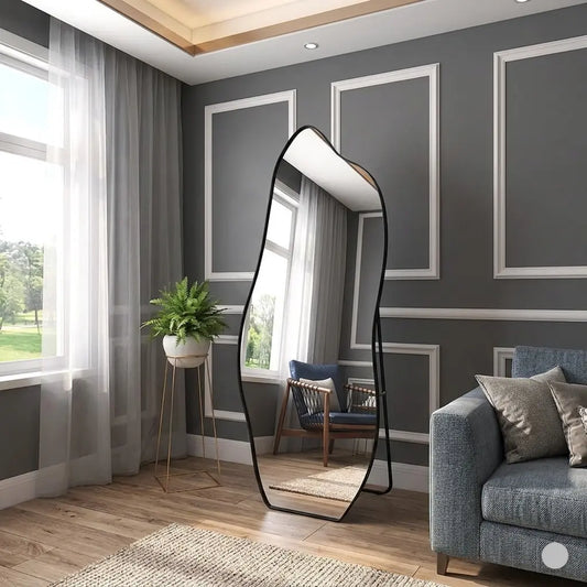 Modern living room with a tall floor mirror, gray walls, and a blue sofa.