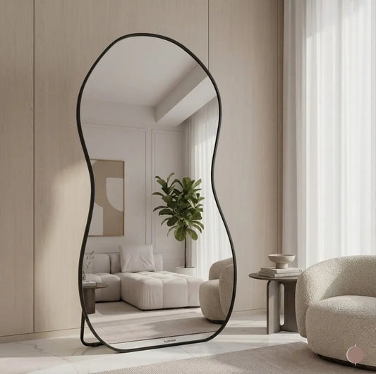 Modern floor mirror with black frame in a stylish living room.