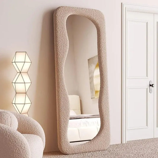 Full-length asymmetric floor standing mirror with a thick beige boucle fabric upholstered frame, 