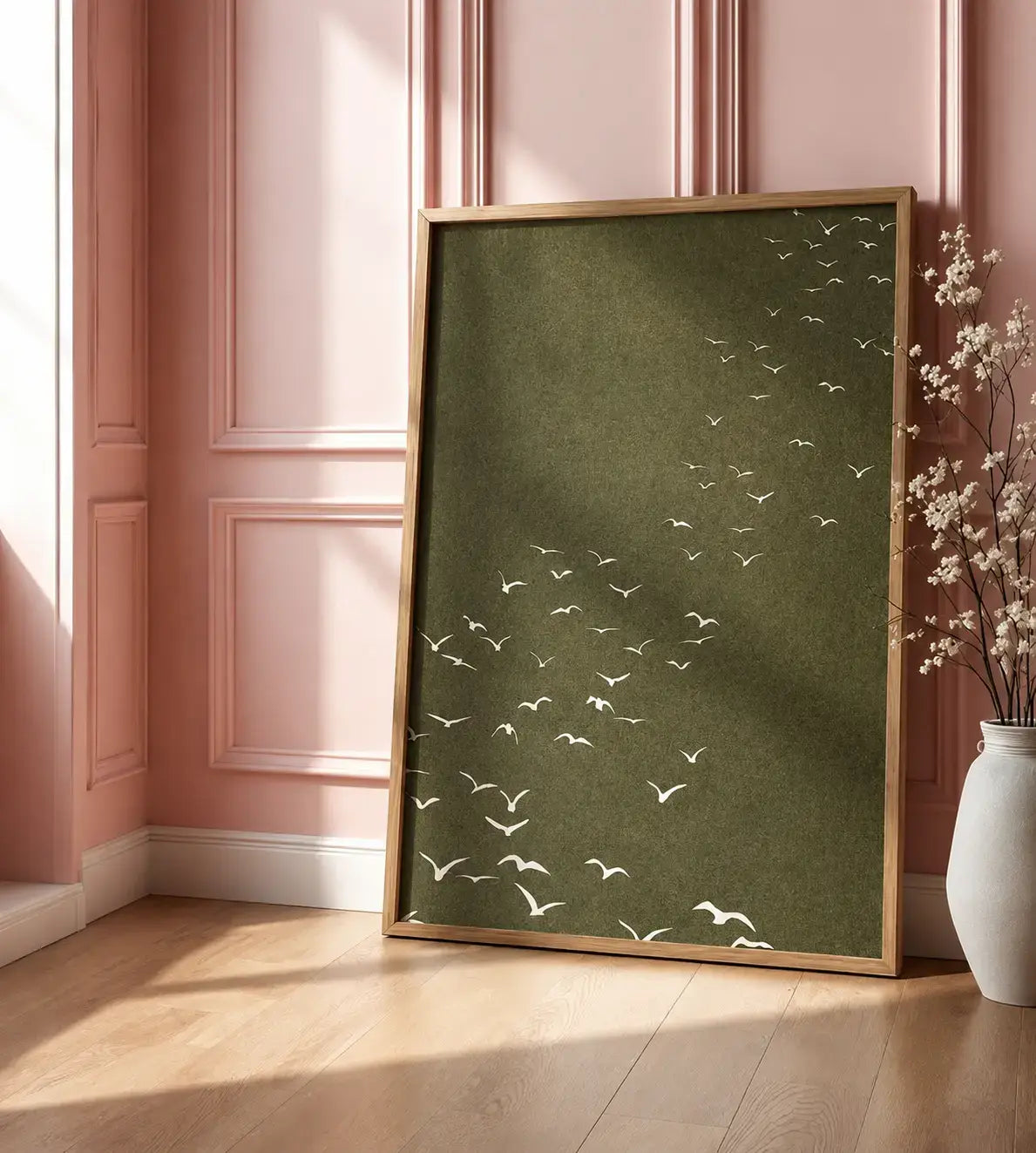 Minimal birds wall art featuring white flying birds on an olive-green background with a wooden frame, styled for modern and nature-inspired interiors.