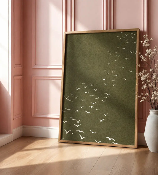 Minimal birds wall art featuring white flying birds on an olive-green background with a wooden frame, styled for modern and nature-inspired interiors.