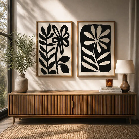 Black and white flower wall art set of 2 in wooden frames above a modern console