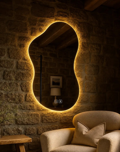 Decorative irregular LED mirror installed on a stone accent wall in a luxury lounge interior