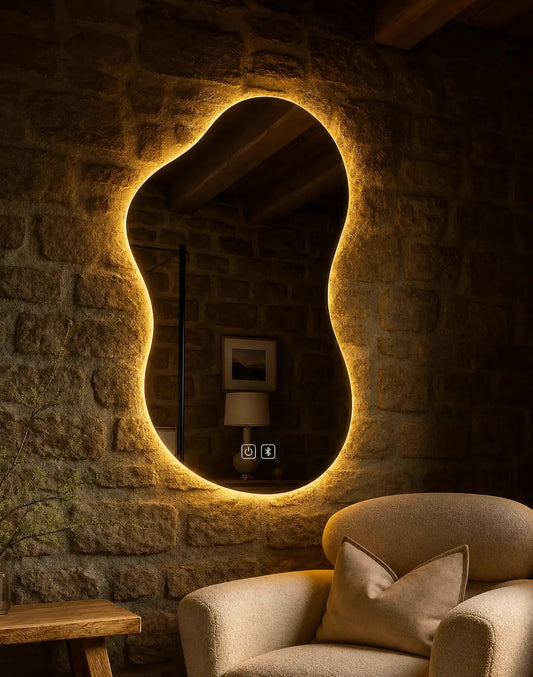 Decorative irregular LED mirror installed on a stone accent wall in a luxury lounge interior