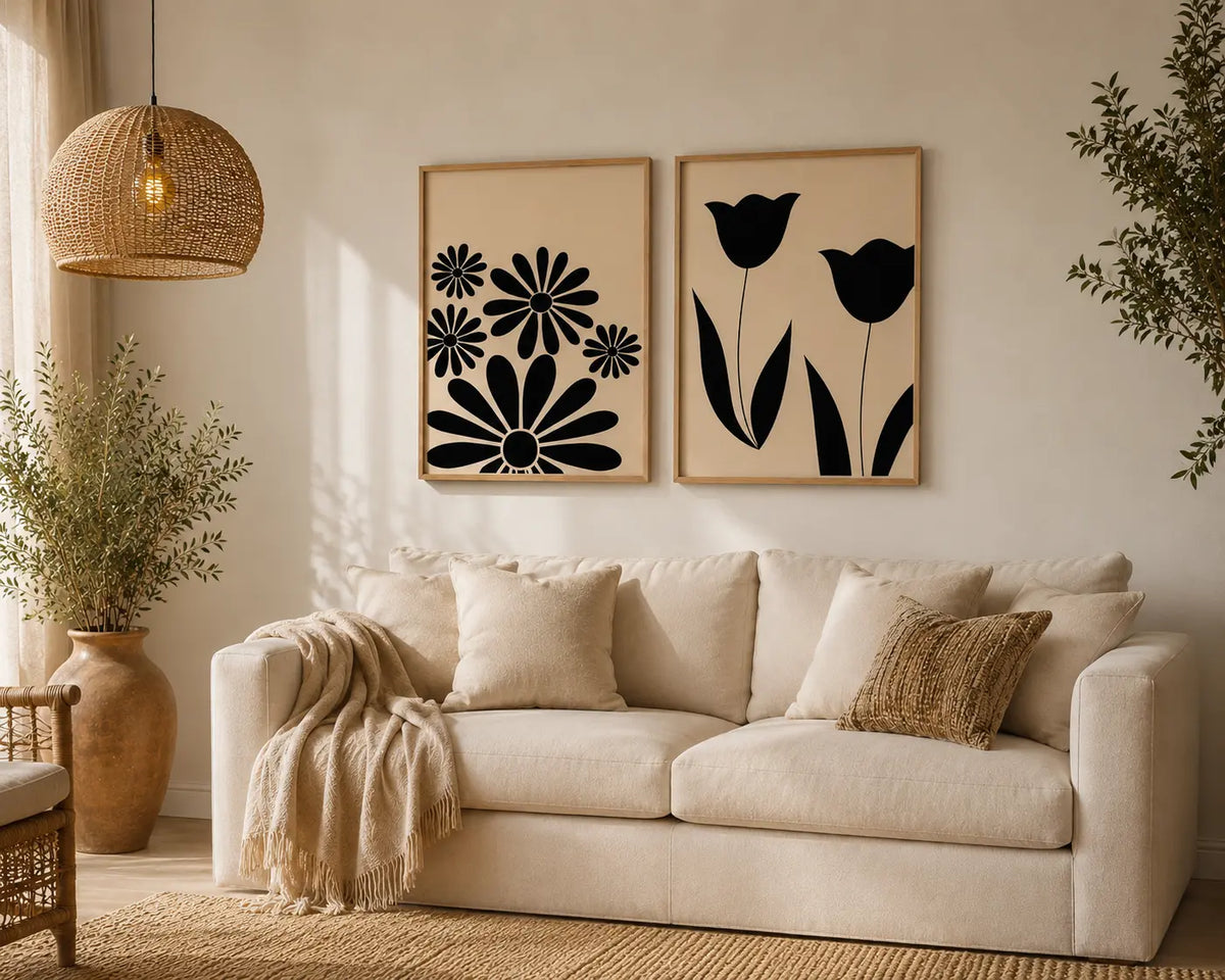 Floral wall art for bedroom set of 2 featuring black daisy and tulip silhouettes in wooden frames above a bed by Decorsz Pakistan.