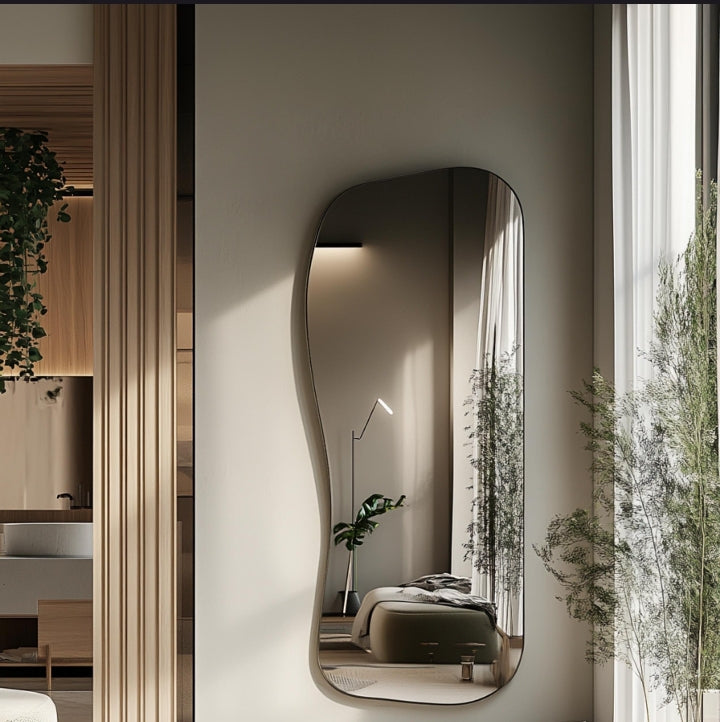 Full-length asymmetrical wall mirror with a sleek thin gold frame