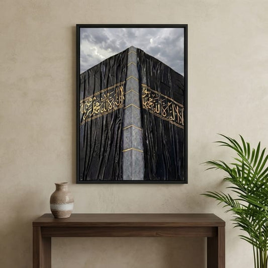 Elegant Kaaba Kiswa wall art featuring detailed golden Islamic calligraphy on a dark Kiswa-inspired design, styled as a premium Islamic wall frame.