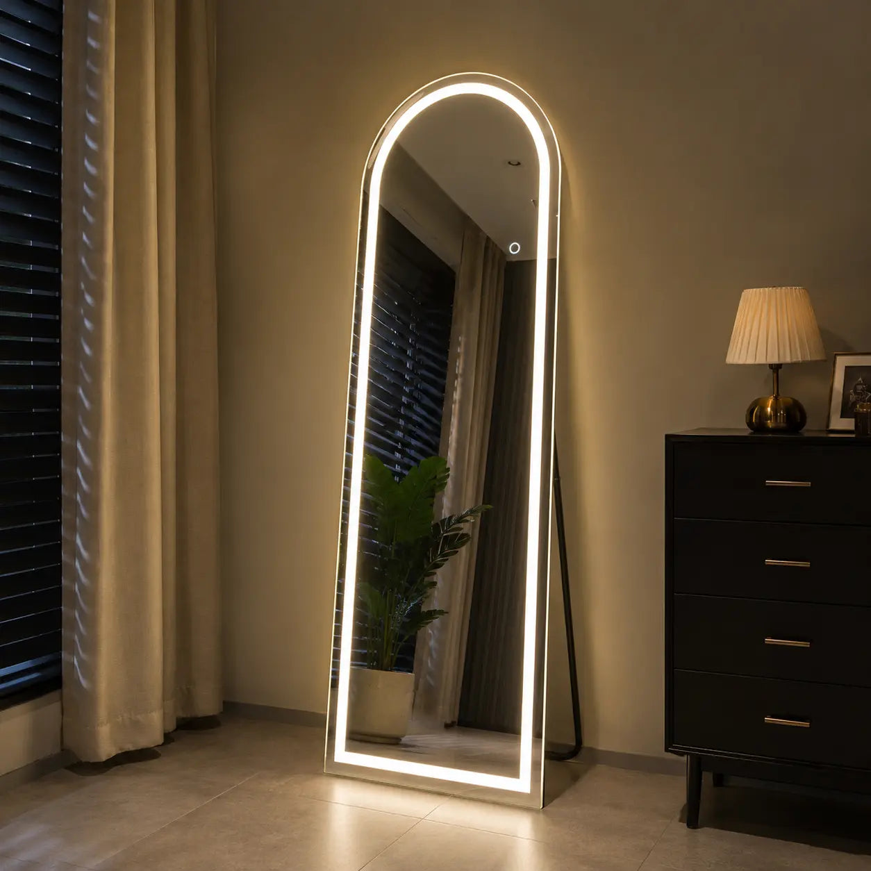 Standing LED mirror with warm lighting for modern bedroom interior